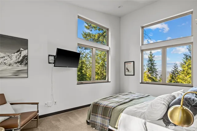 a bedroom with a bed and a painting on the wall