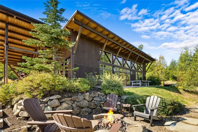 a view of a house with backyard patio and sitting area