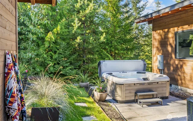 a view of a backyard with plants and outdoor seating