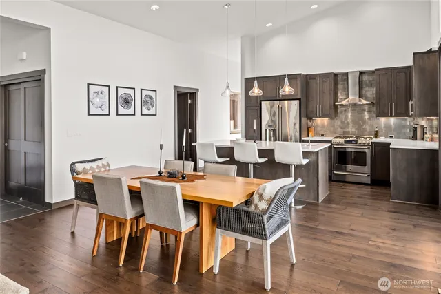 a view of a dining room with furniture wooden floor and kitchen view