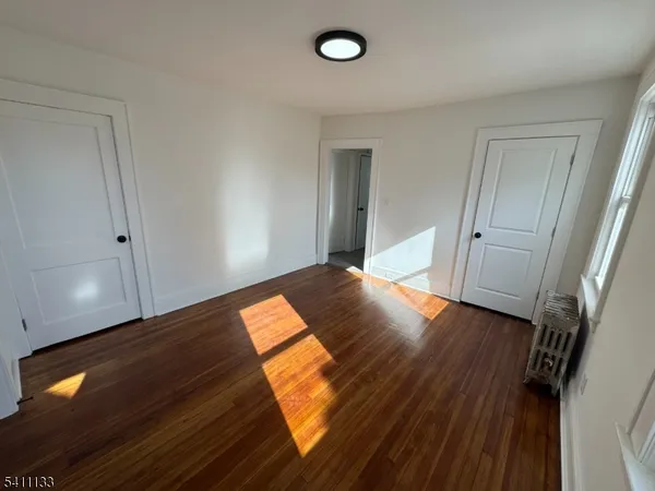 a view of an empty room and wooden floor