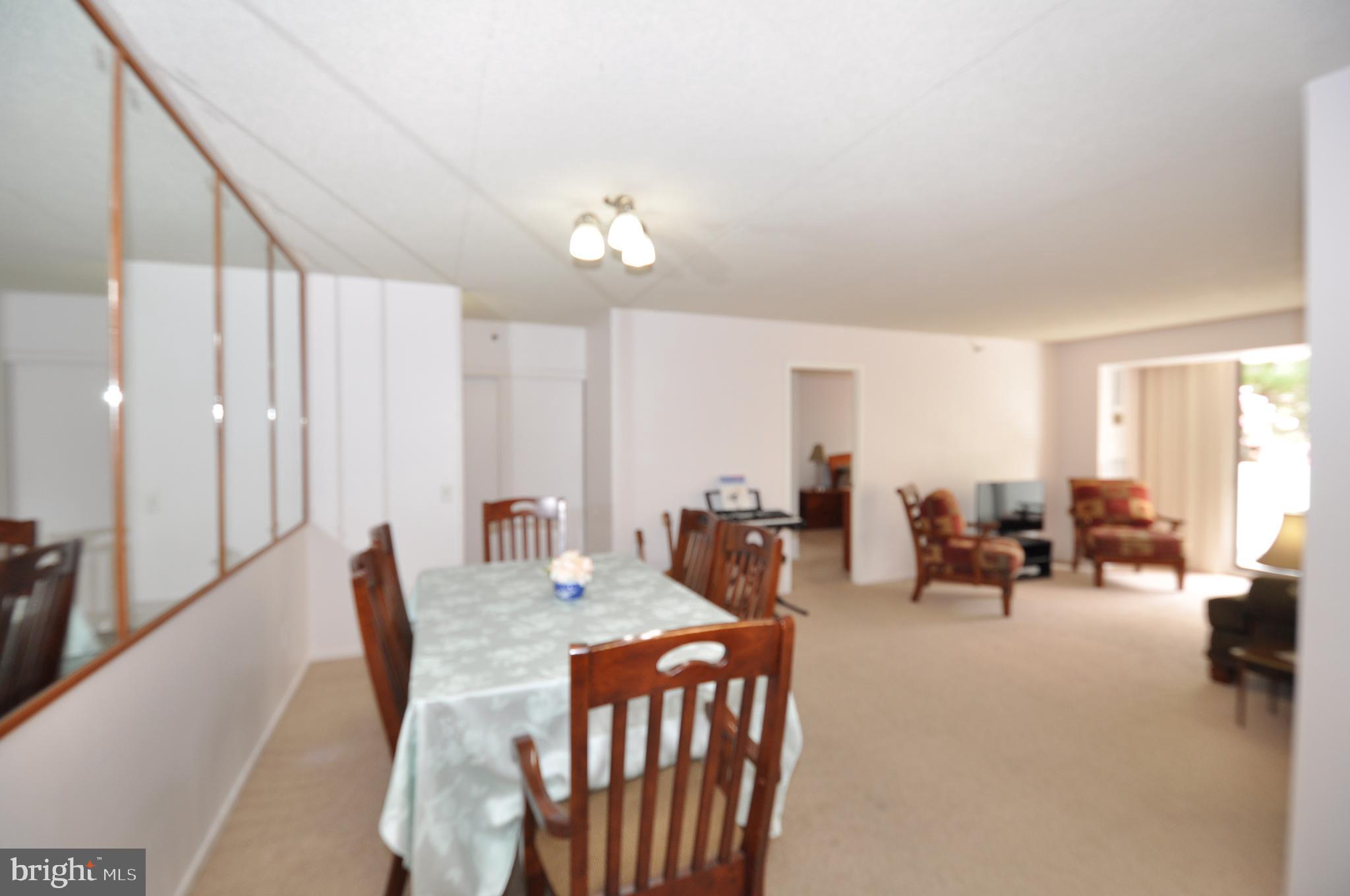 5911 Edsall Road, Unit 403 Alexandria, VA 22304 - Photo 7 of 29 a living room with furniture and large windows