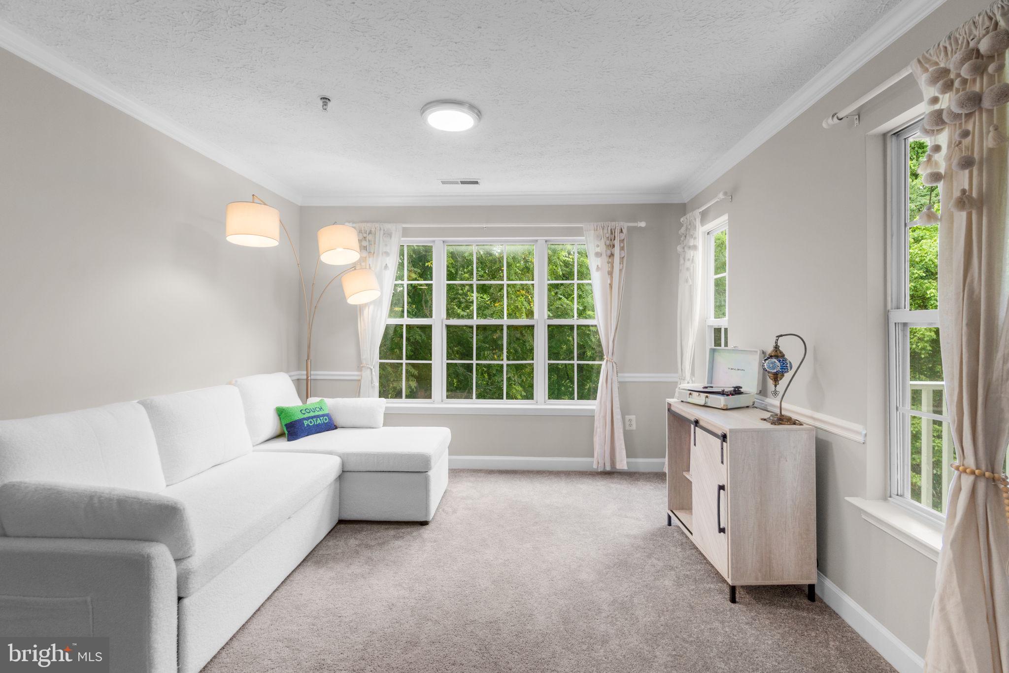 6509 Springwater Court, Unit 6303 Frederick, MD 21701 - Photo 12 of 48 a living room with furniture and a large window