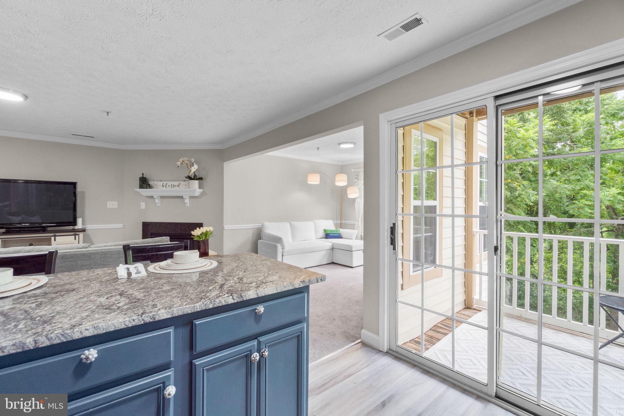 6509 Springwater Court, Unit 6303 Frederick, MD 21701 - Photo 17 of 48 a kitchen with granite countertop a sink and a large window