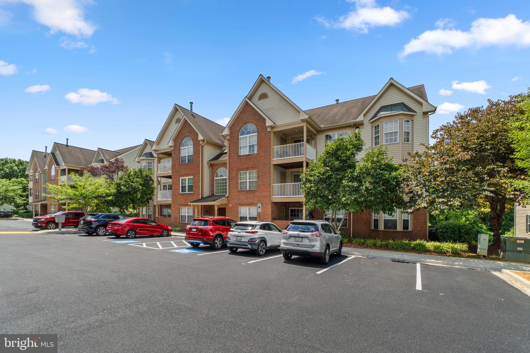 6509 Springwater Court, Unit 6303 Frederick, MD 21701 - Photo 2 of 48 a car parked in front of a house with large trees
