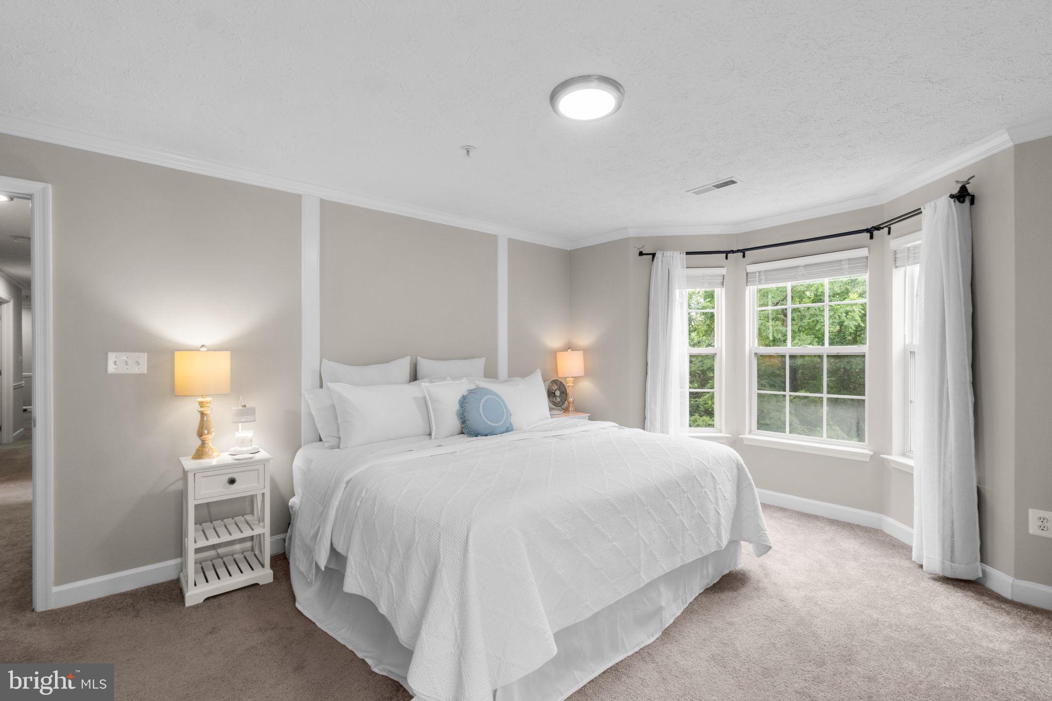 6509 Springwater Court, Unit 6303 Frederick, MD 21701 - Photo 21 of 48 a bedroom with a bed and a large window