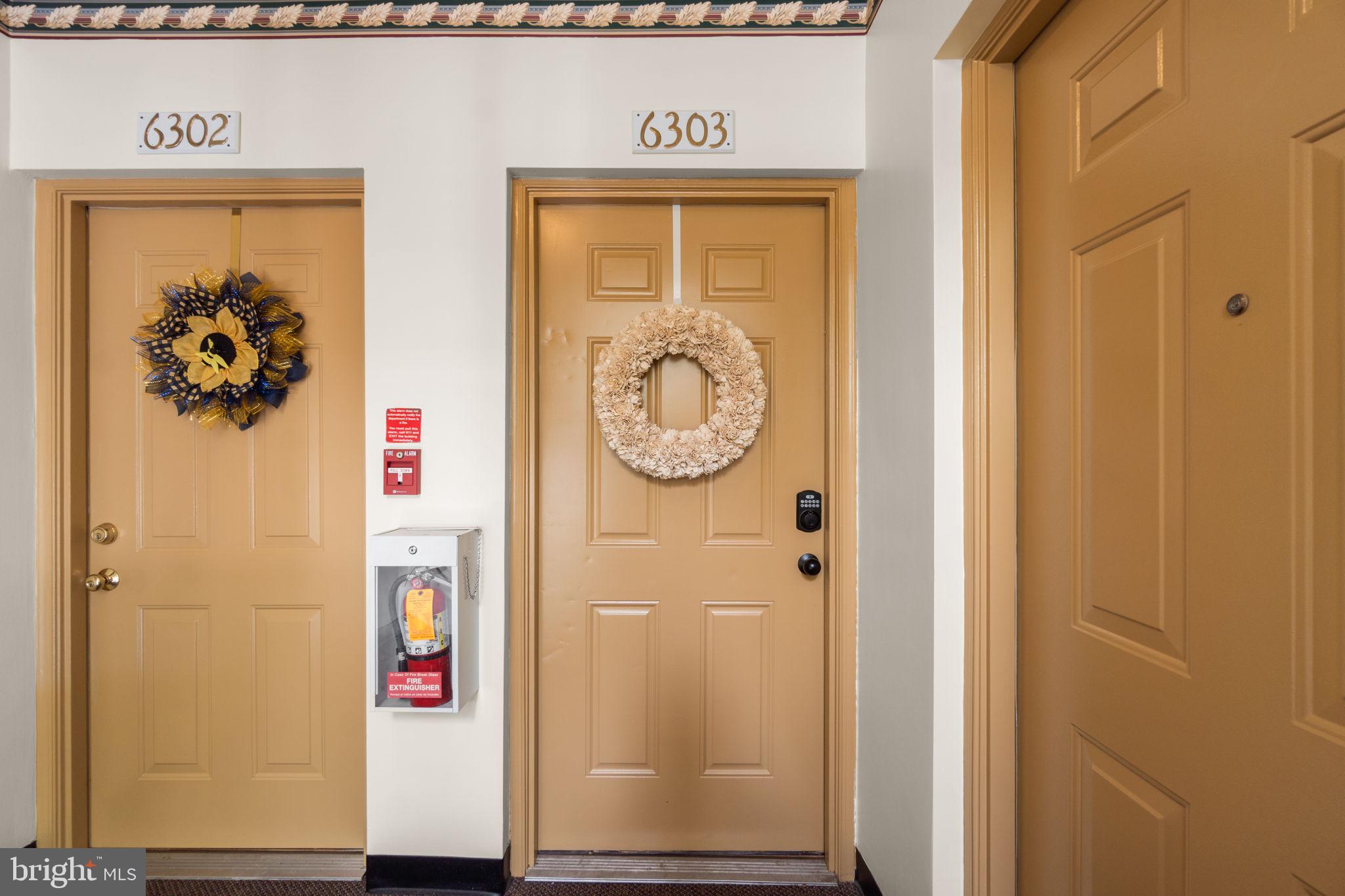 6509 Springwater Court, Unit 6303 Frederick, MD 21701 - Photo 5 of 48 a view of a hallway with paintings on the wall