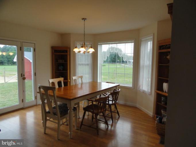 8235 Detour Road Denton, MD 21629 - Photo 7 of 30 a view of a dining room with furniture window and wooden floor