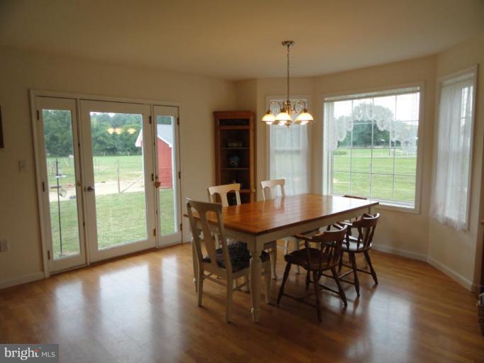 8235 Detour Road Denton, MD 21629 - Photo 8 of 30 a view of a dining room with furniture window and wooden floor