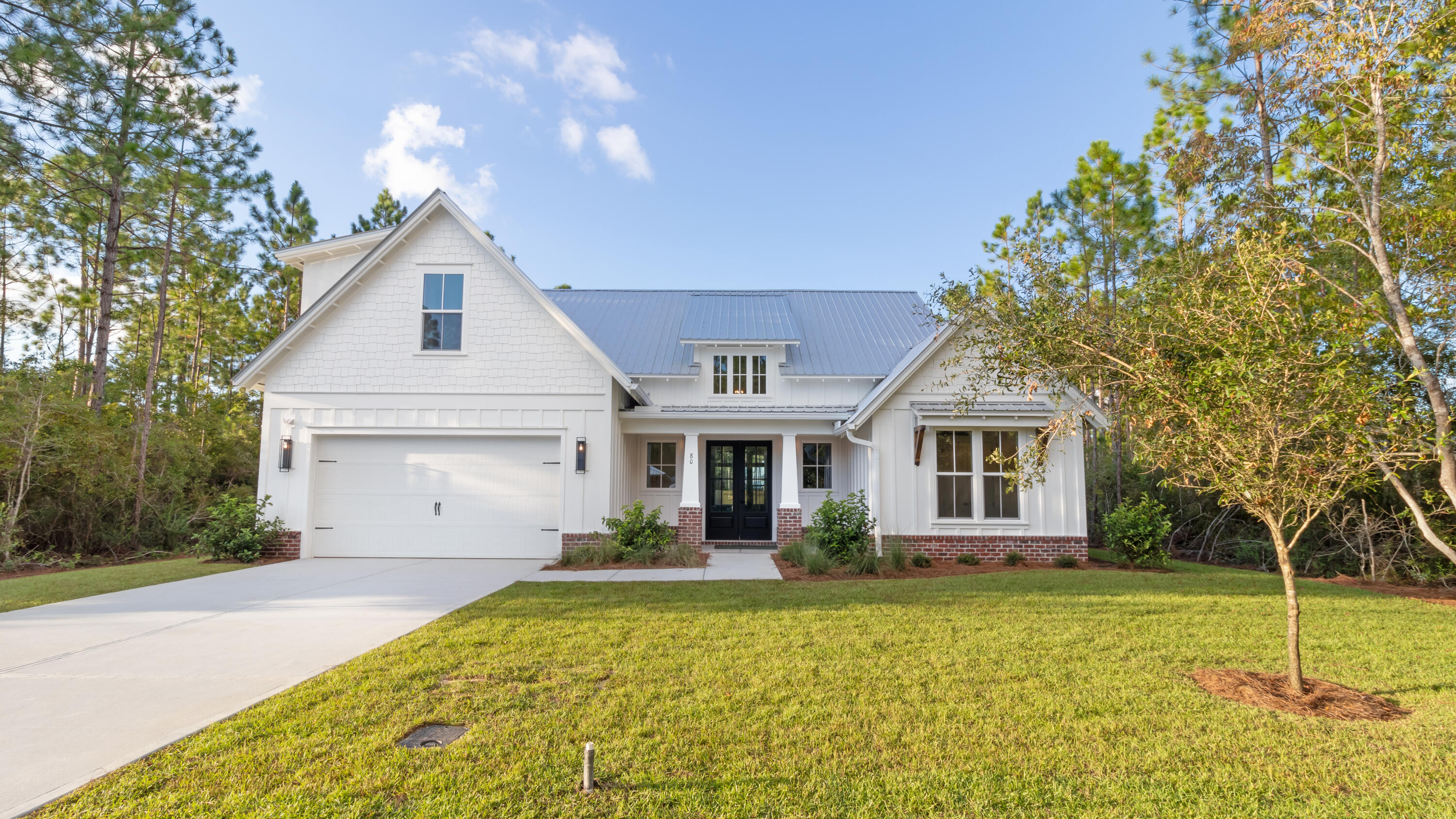 80 Muzzle Street Freeport, FL 32439 - Photo 1 of 71 a front view of a house with a garden