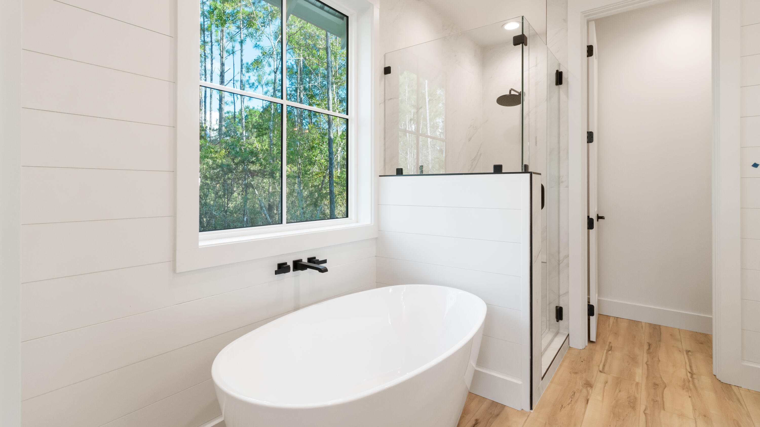 80 Muzzle Street Freeport, FL 32439 - Photo 26 of 71 a bathroom with a tub a sink and a window