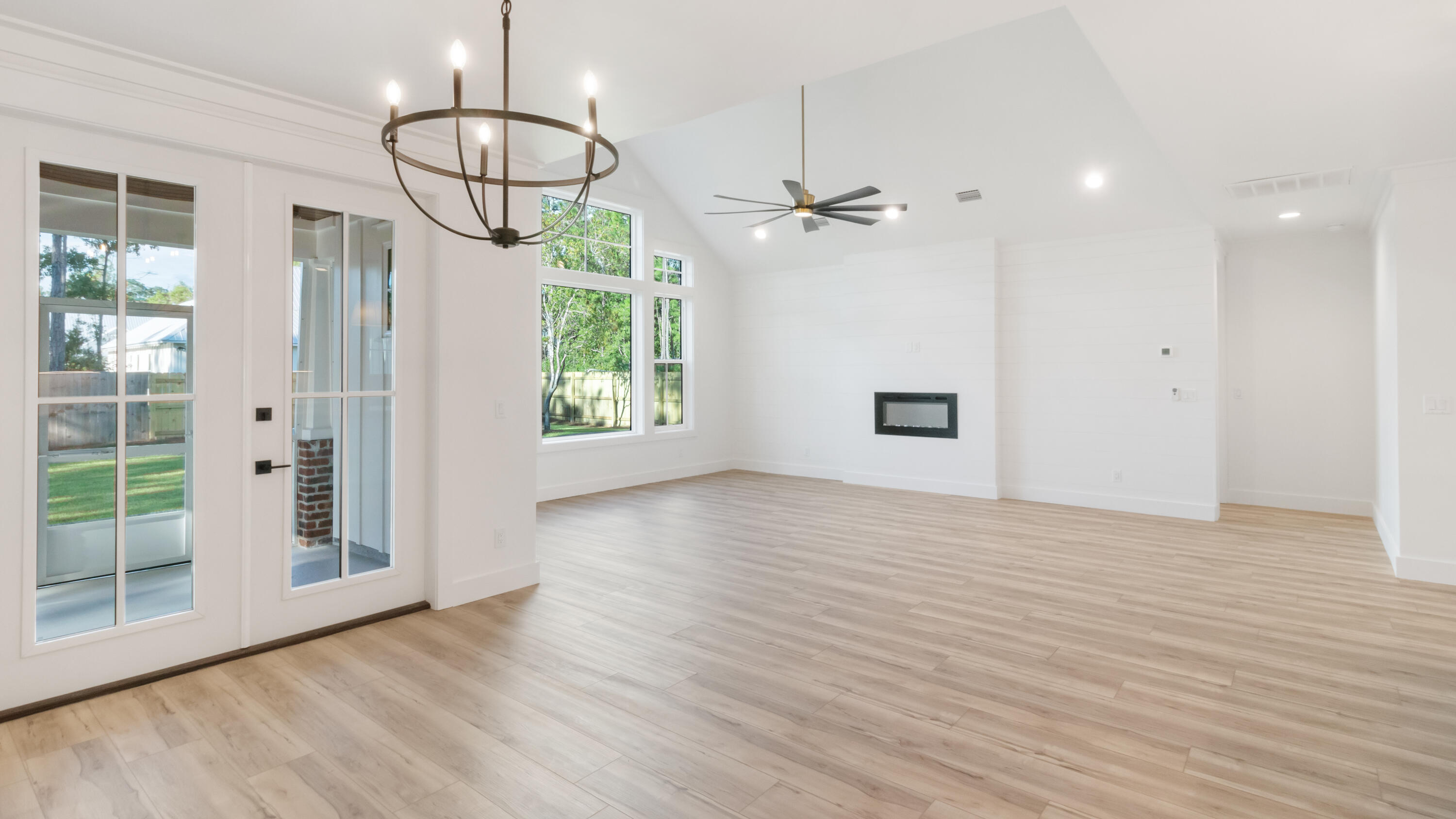 80 Muzzle Street Freeport, FL 32439 - Photo 3 of 71 a view of empty room with wooden floor and fan