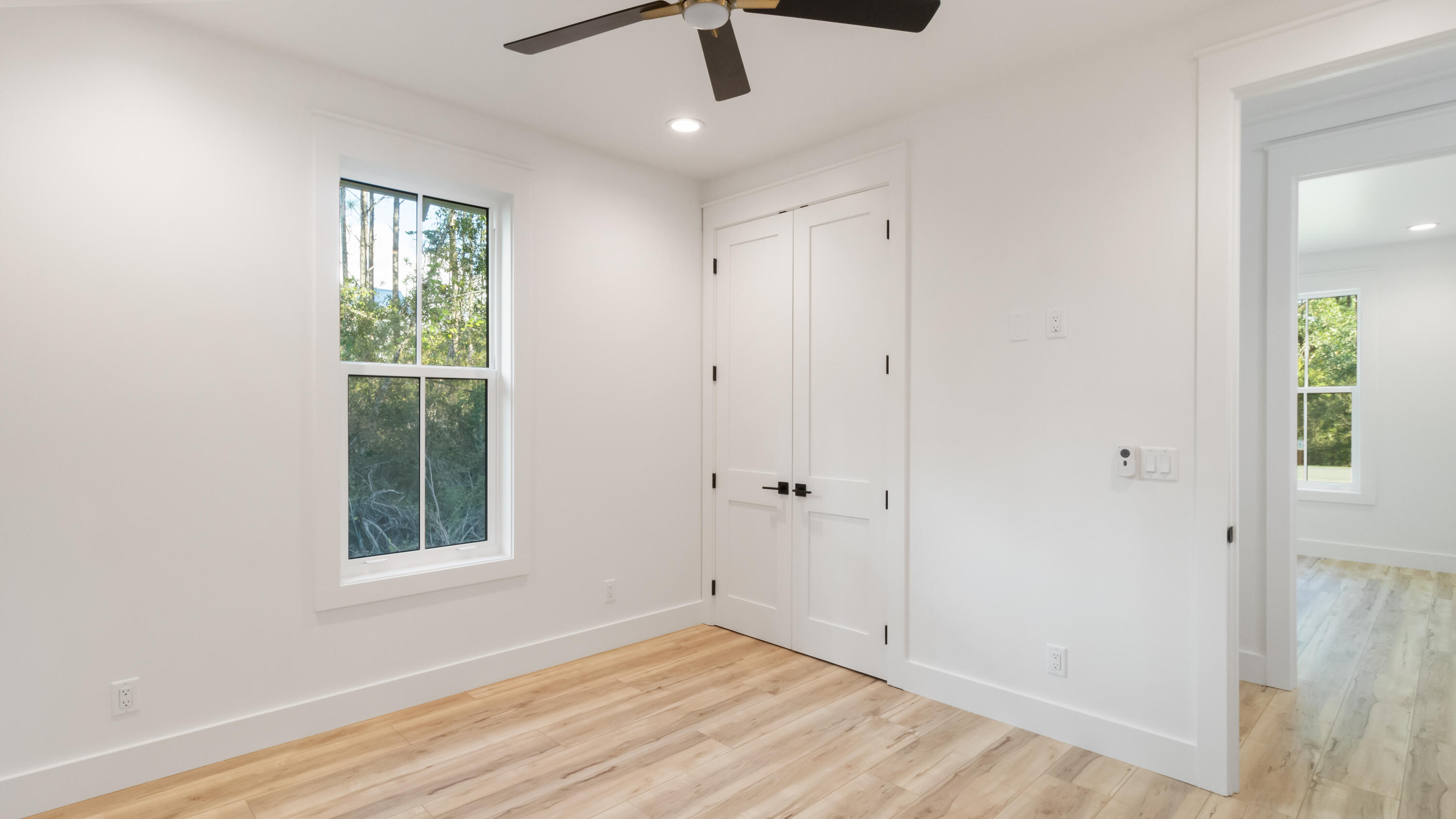 80 Muzzle Street Freeport, FL 32439 - Photo 32 of 71 wooden floor in an empty room with a window