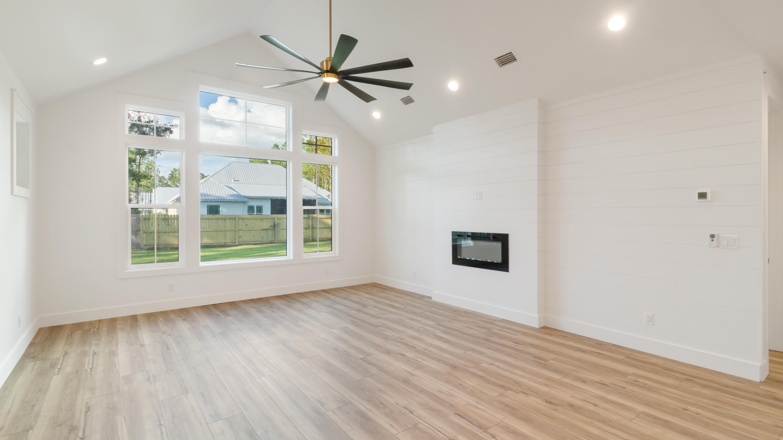 80 Muzzle Street Freeport, FL 32439 - Photo 4 of 71 an empty room with wooden floor fan and windows