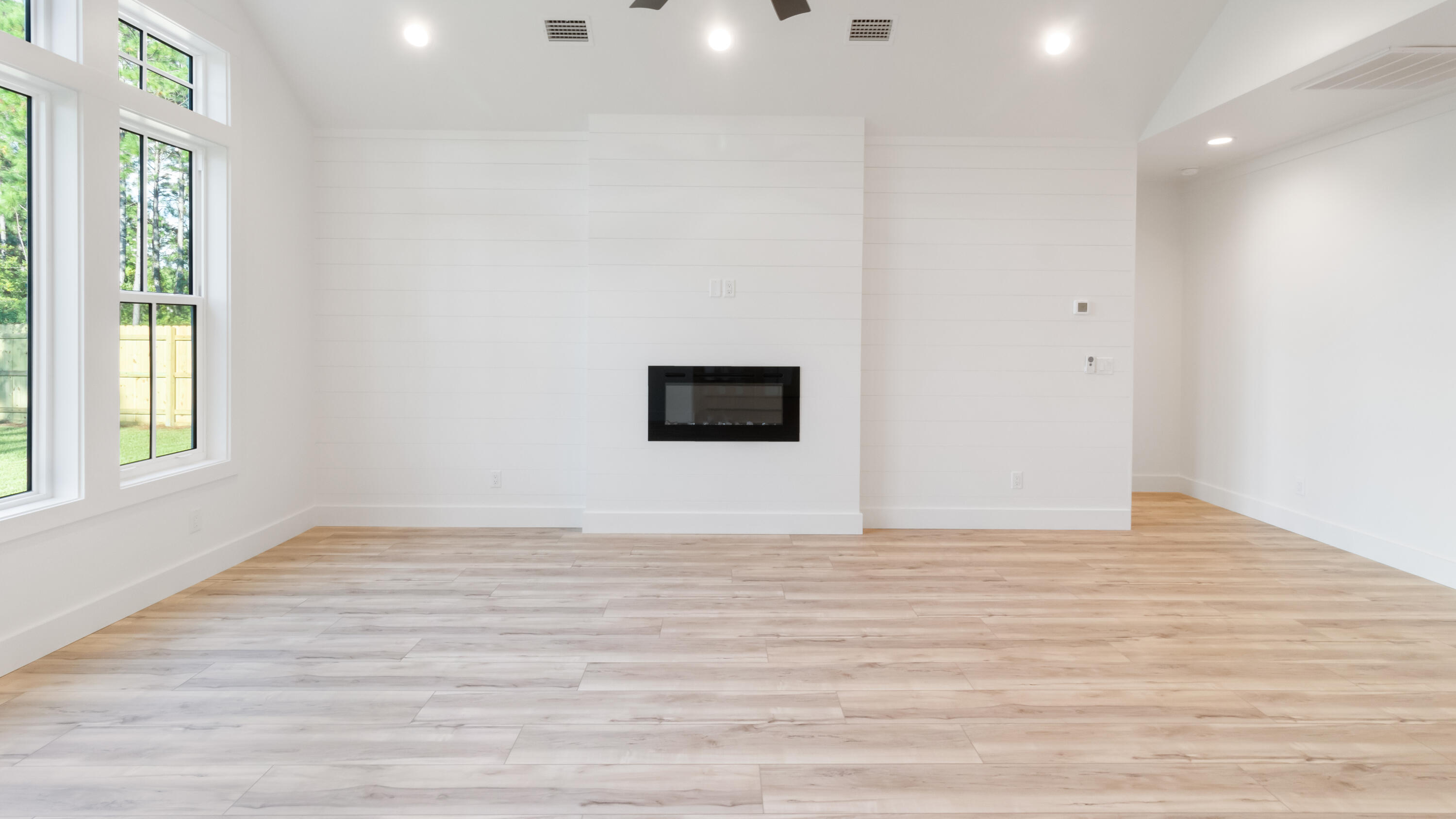 80 Muzzle Street Freeport, FL 32439 - Photo 44 of 71 a view of an empty room with a window and wooden floor