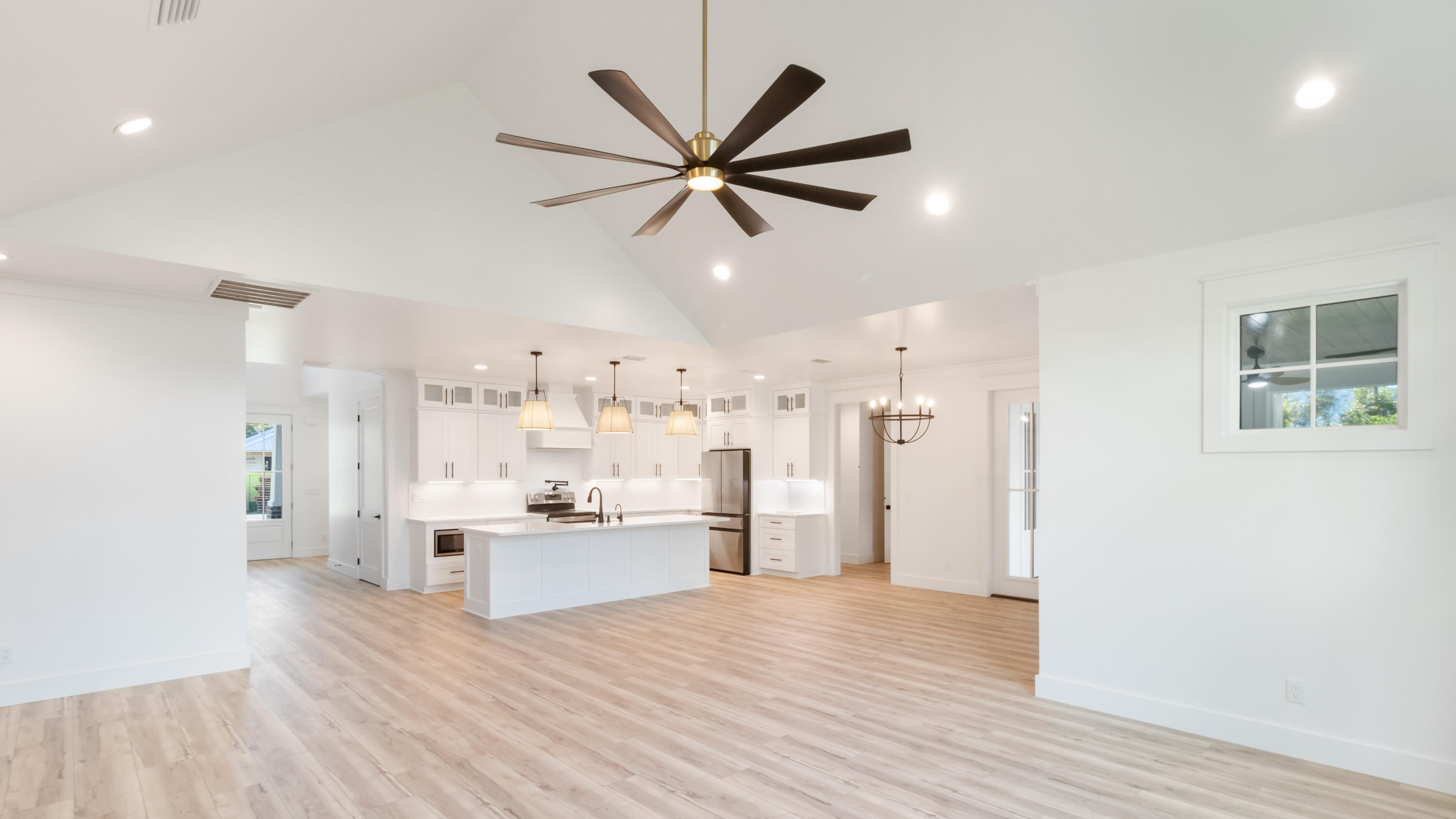 80 Muzzle Street Freeport, FL 32439 - Photo 45 of 71 a kitchen with stainless steel appliances a refrigerator a sink dishwasher and a stove top oven with wooden floor
