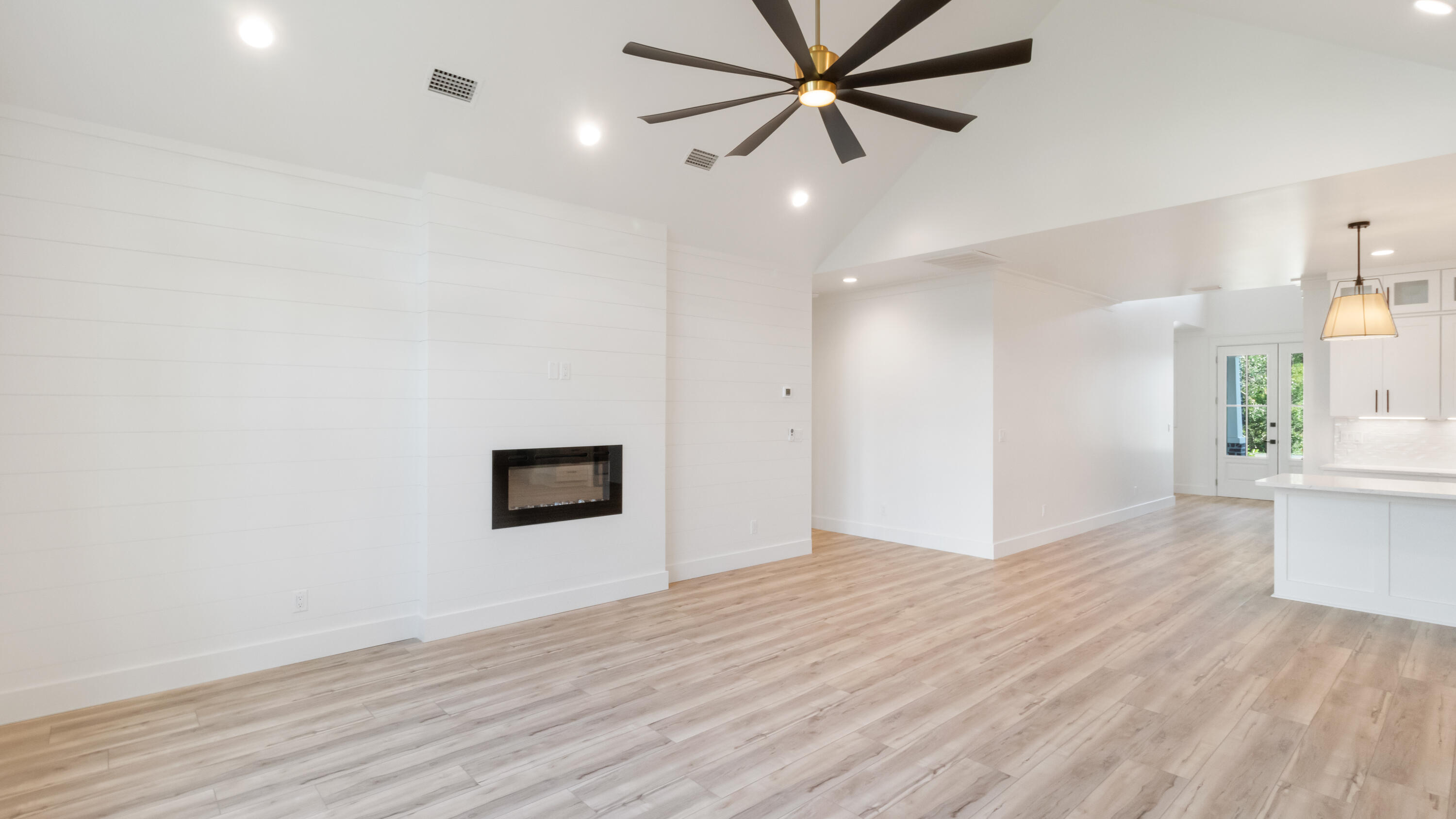 80 Muzzle Street Freeport, FL 32439 - Photo 46 of 71 a view of a hallway with wooden floor and a ceiling fan