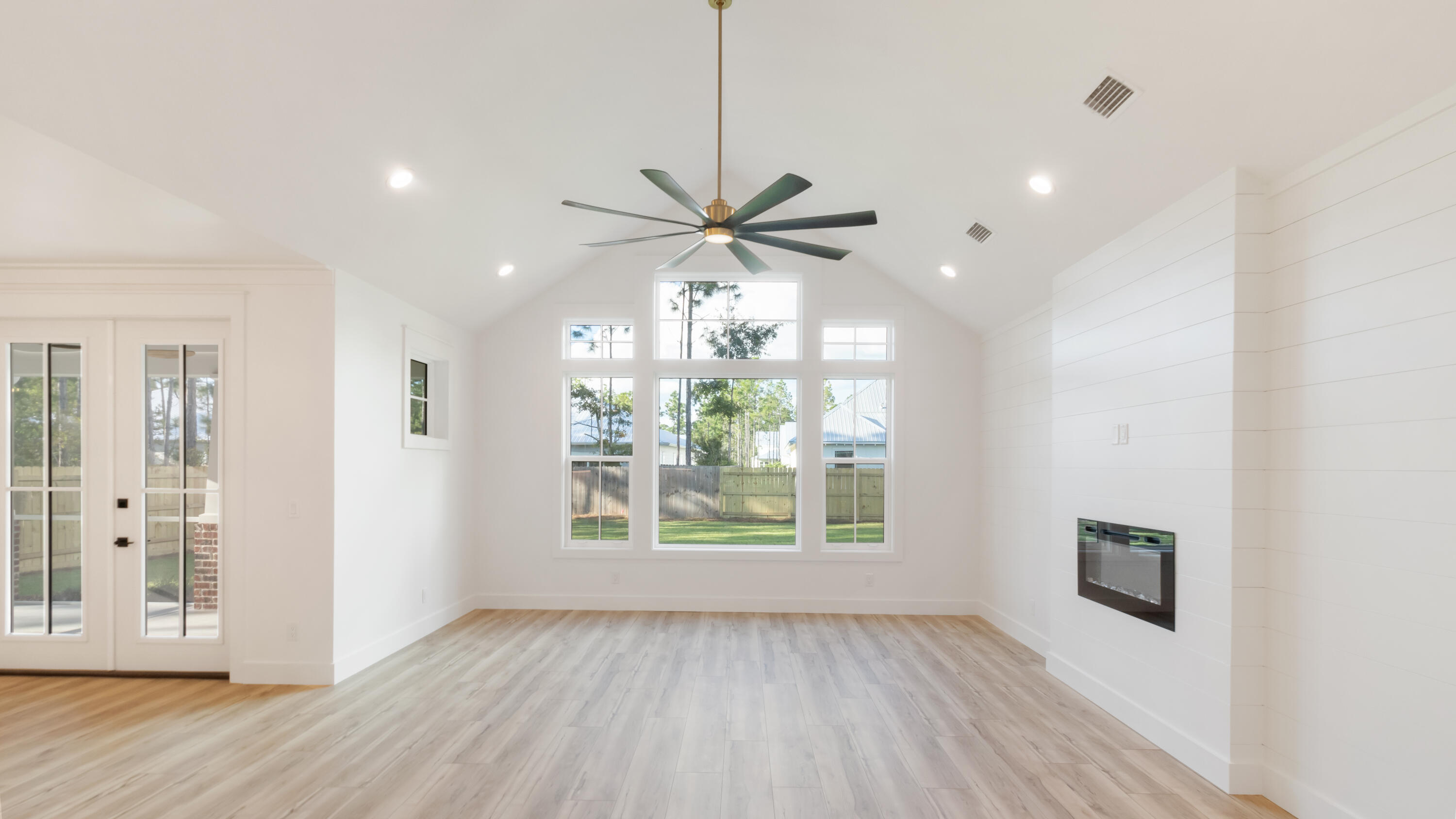 80 Muzzle Street Freeport, FL 32439 - Photo 51 of 71 a view of an empty room with a window and wooden floor