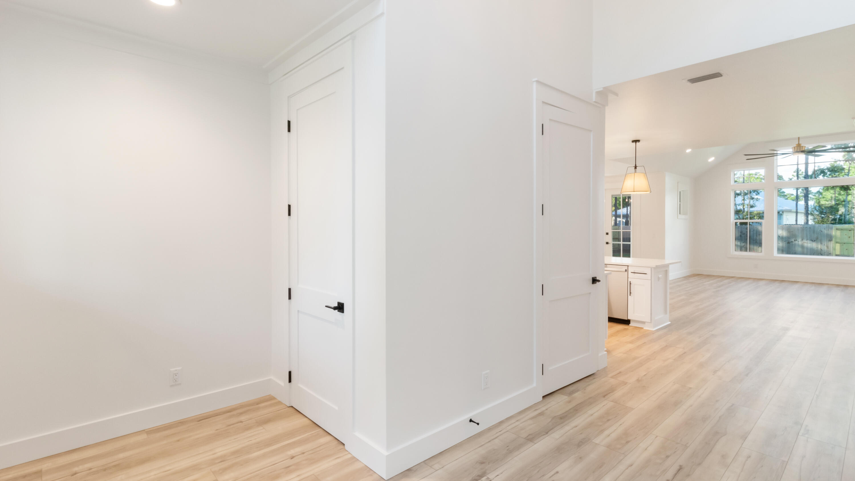 80 Muzzle Street Freeport, FL 32439 - Photo 56 of 71 an empty room with wooden floor and windows