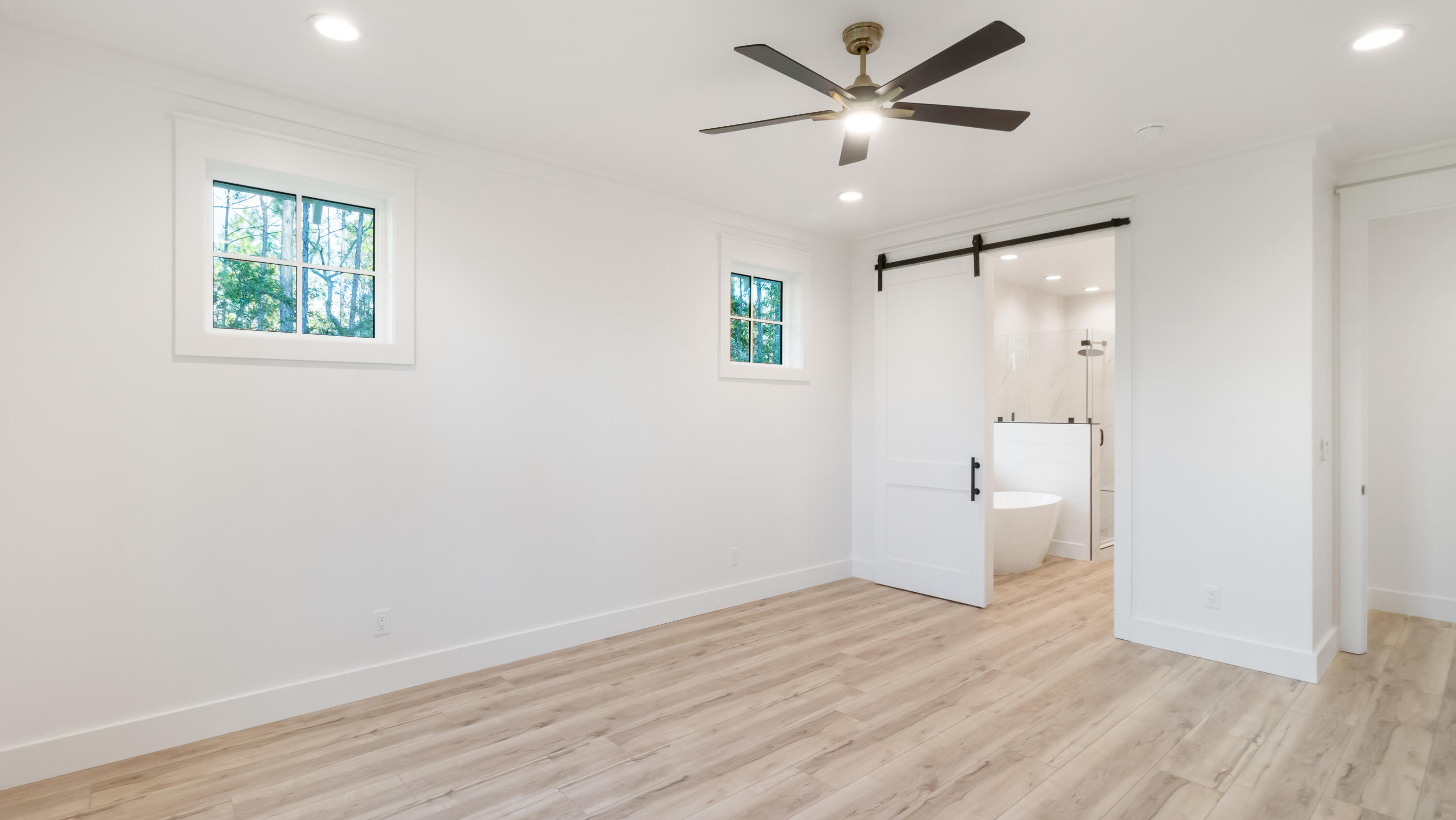 80 Muzzle Street Freeport, FL 32439 - Photo 6 of 71 an empty room with wooden floor and a ceiling fan