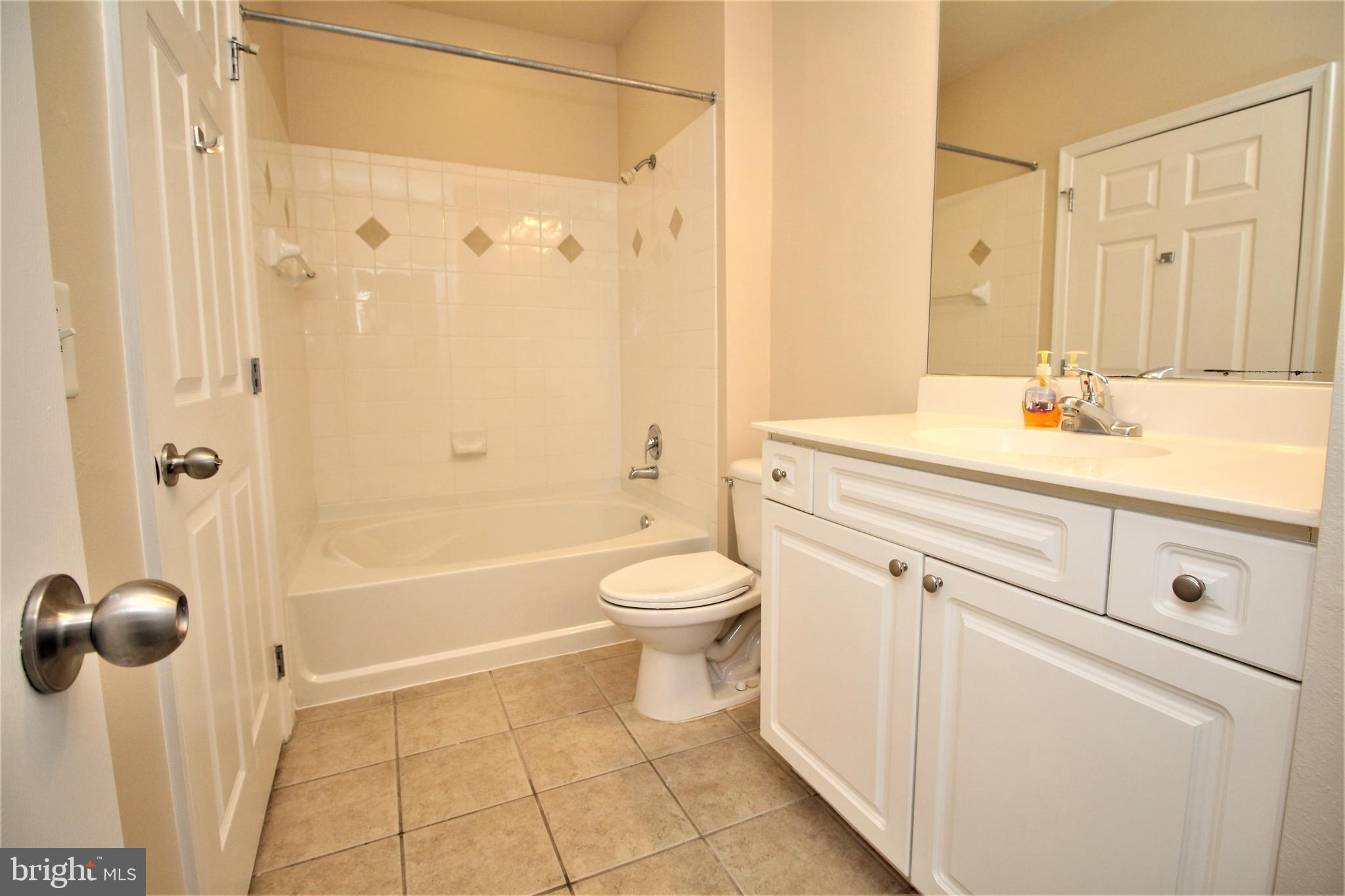 501 Hungerford Drive, Unit 137 Rockville, MD 20850 - Photo 12 of 37 a bathroom with a sink a toilet and shower