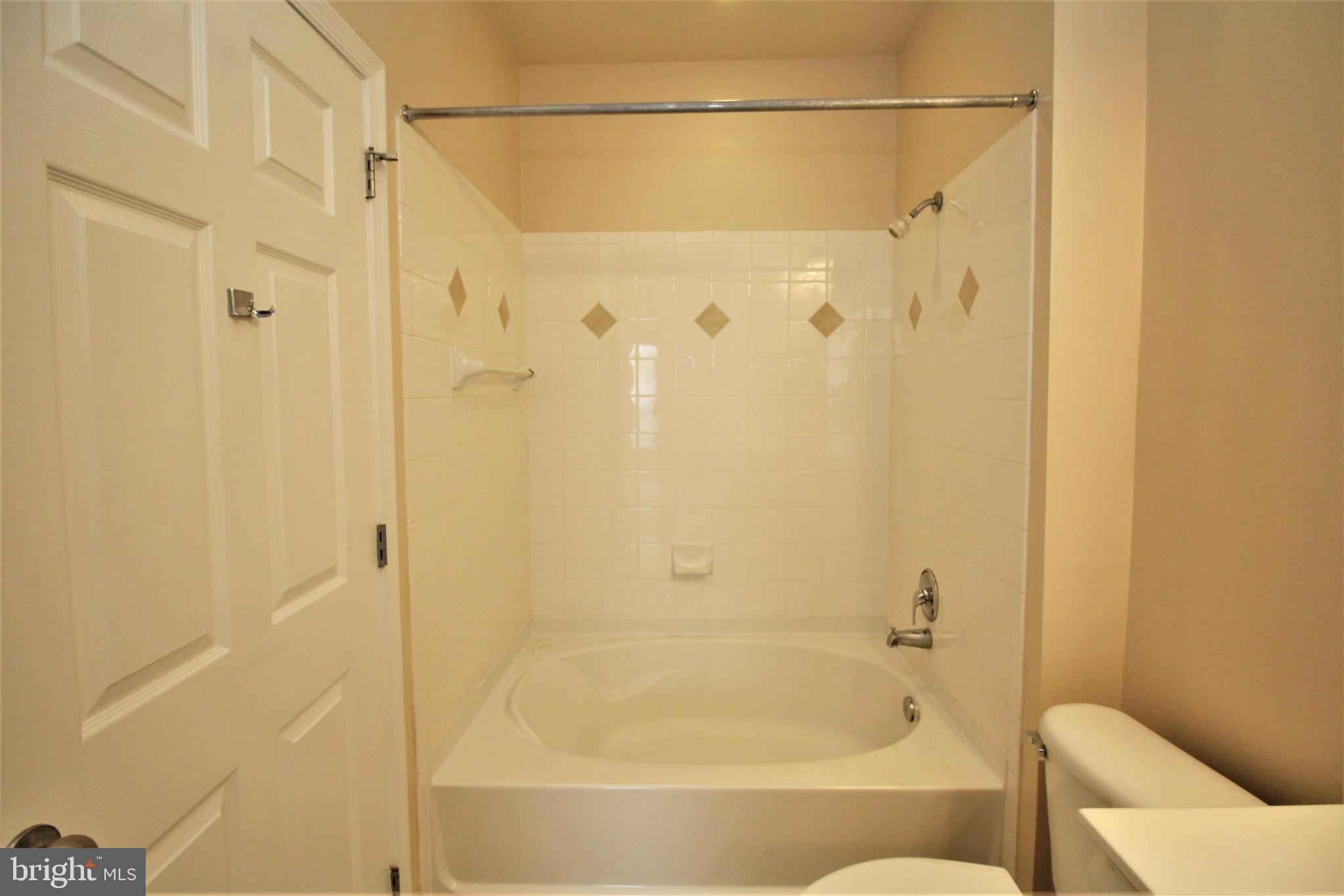 501 Hungerford Drive, Unit 137 Rockville, MD 20850 - Photo 13 of 37 a bathroom with a bathtub and shower
