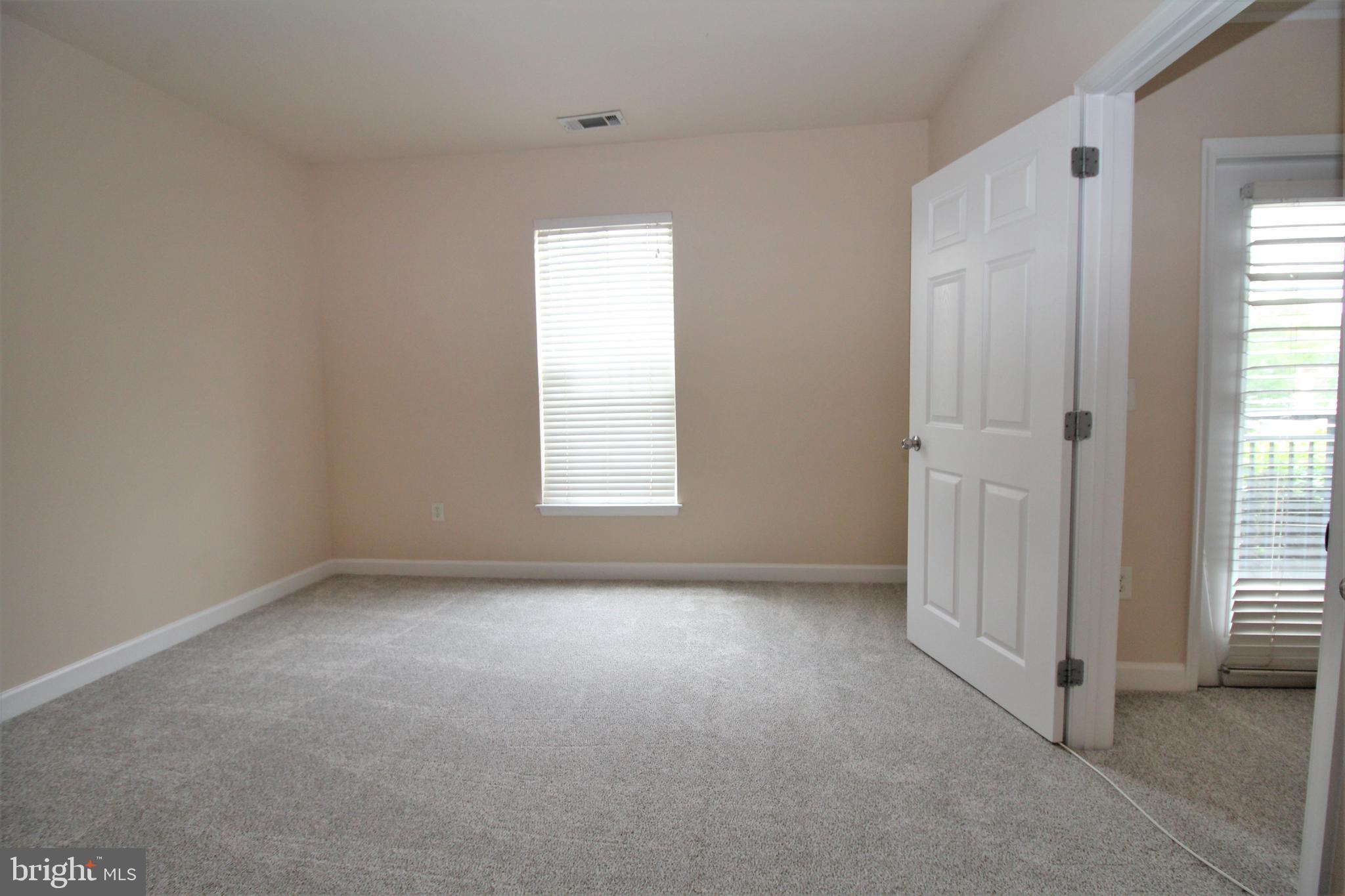 501 Hungerford Drive, Unit 137 Rockville, MD 20850 - Photo 19 of 37 an empty room with windows