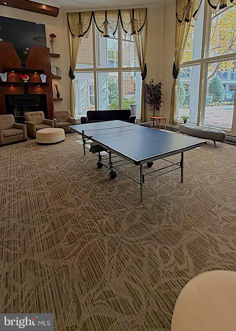 501 Hungerford Drive, Unit 137 Rockville, MD 20850 - Photo 30 of 37 a living room with furniture a large window and wooden floor