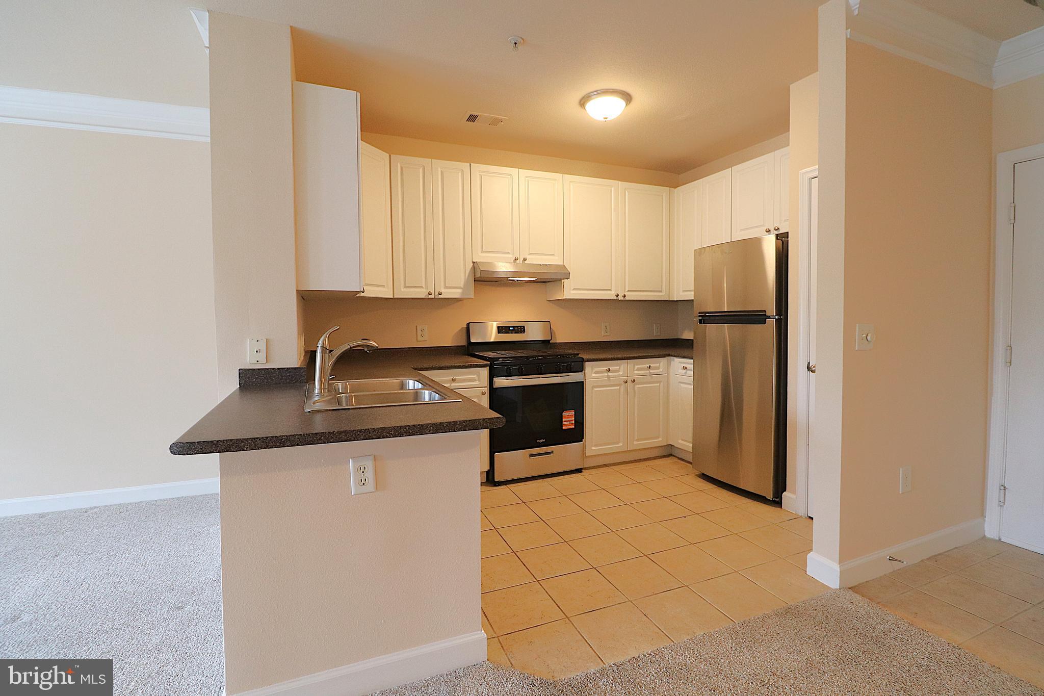 501 Hungerford Drive, Unit 137 Rockville, MD 20850 - Photo 3 of 37 a kitchen with stainless steel appliances granite countertop a sink stove and refrigerator
