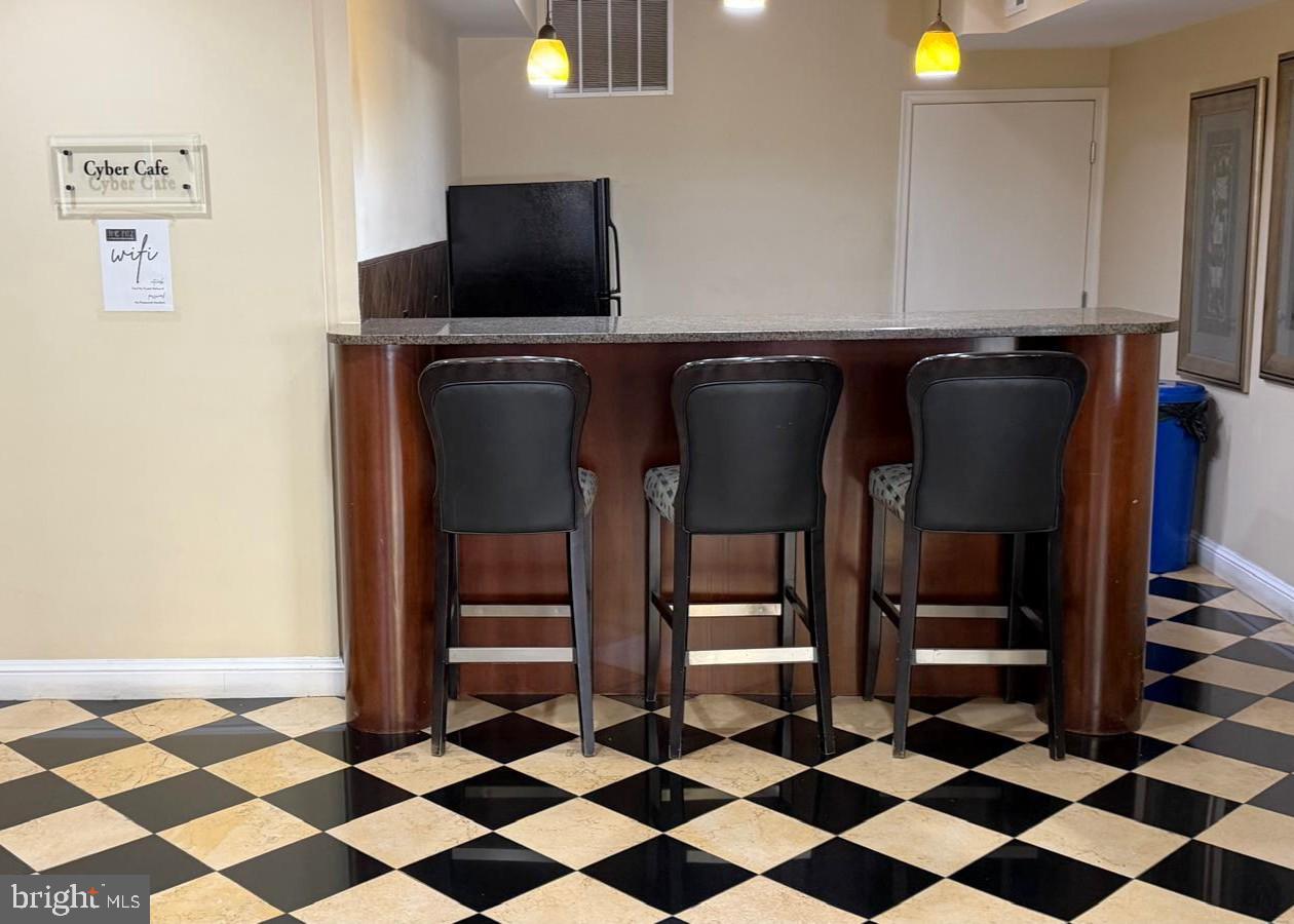 501 Hungerford Drive, Unit 137 Rockville, MD 20850 - Photo 36 of 37 a black and white kitchen with a stove a sink and a refrigerator