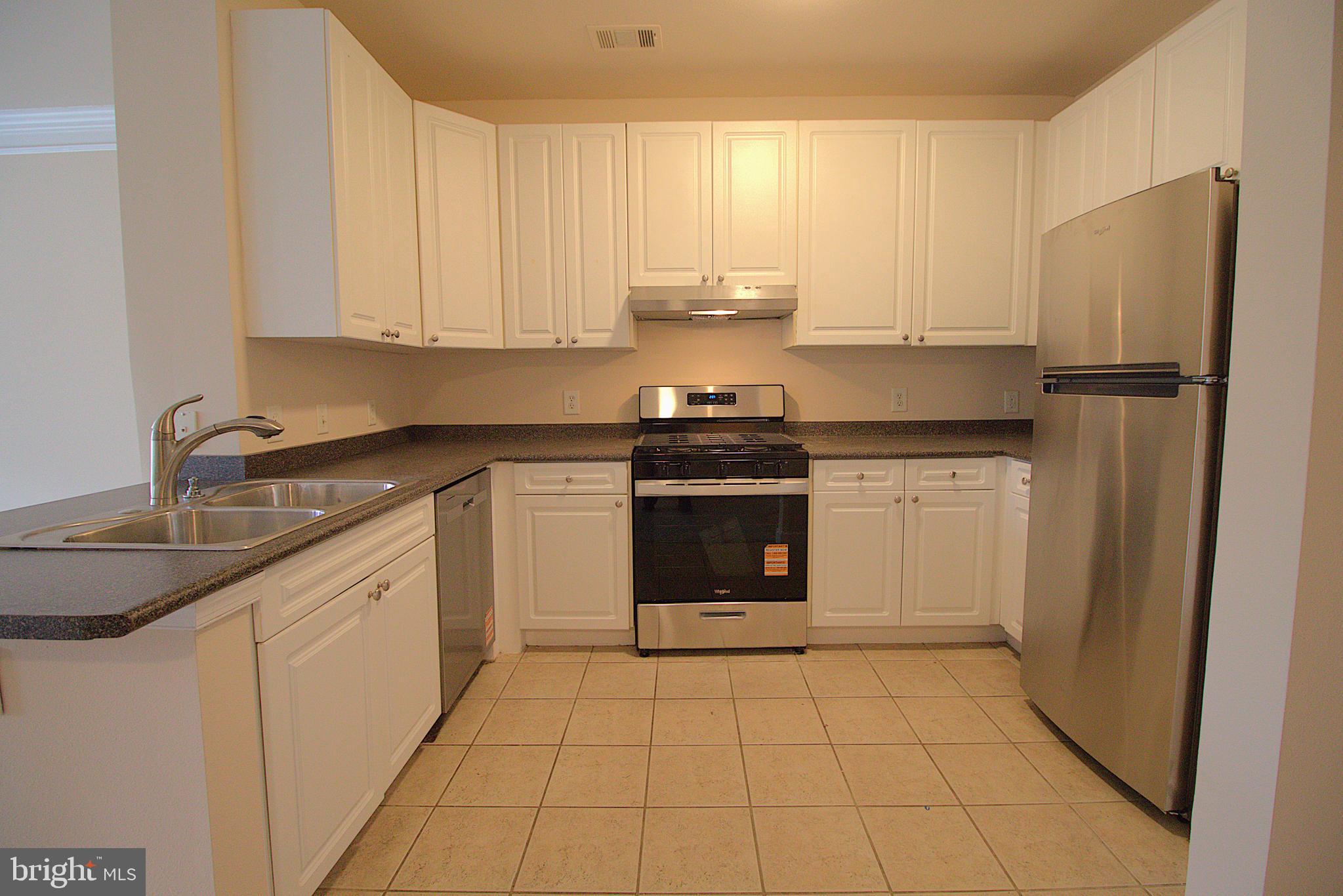 501 Hungerford Drive, Unit 137 Rockville, MD 20850 - Photo 4 of 37 a kitchen with a stove sink and refrigerator
