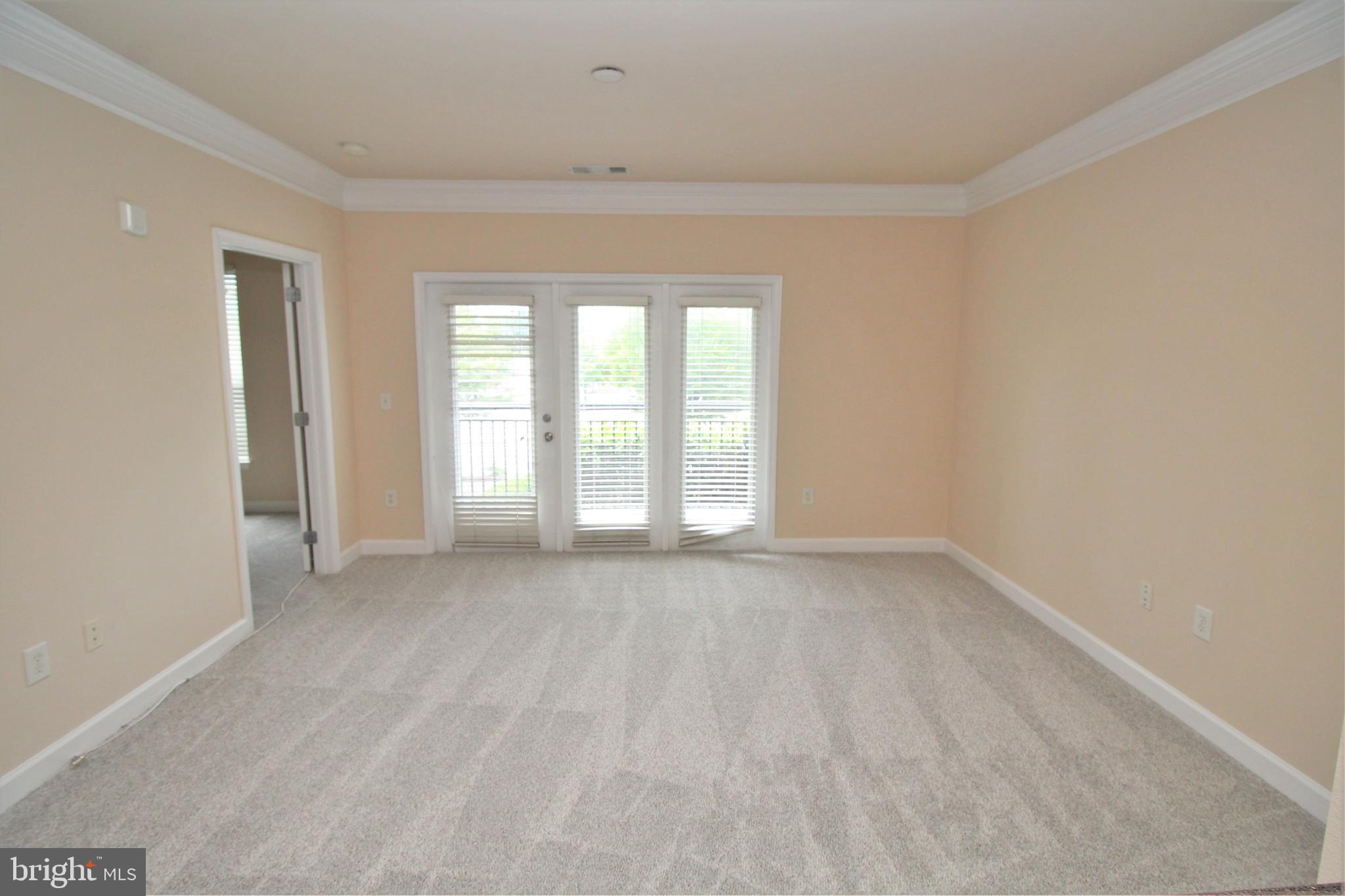 501 Hungerford Drive, Unit 137 Rockville, MD 20850 - Photo 6 of 37 a view of an empty room with a window
