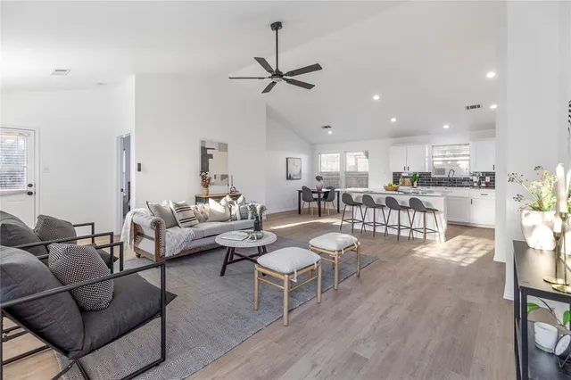 a living room with furniture and kitchen view