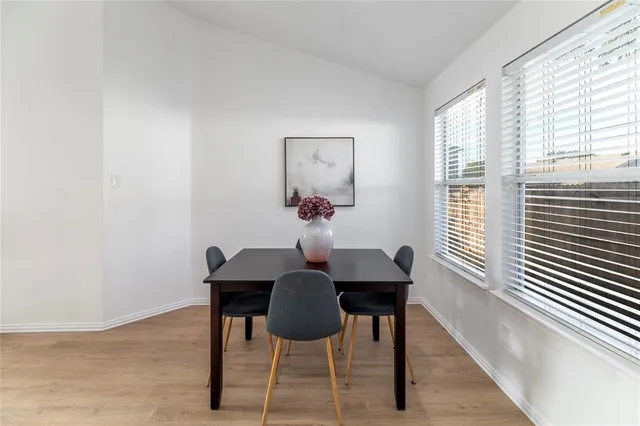 a dining room with furniture and window
