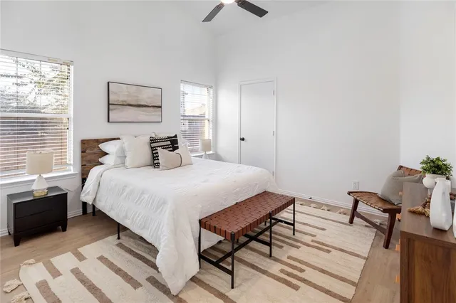 a bedroom with a bed and a chandelier
