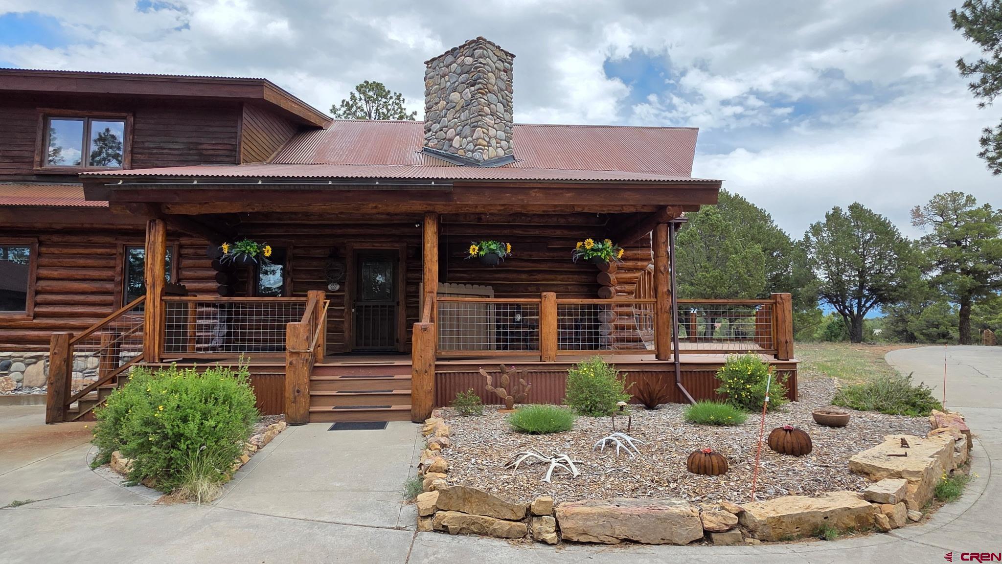 653 Marmot Drive Ridgway, CO 81432 - Photo 36 of 45 a view of a house with potted plants and a fountain