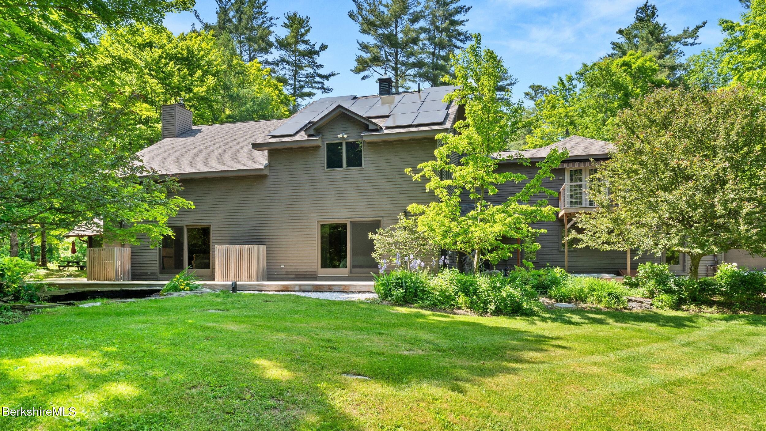 173 Hillsdale Road Egremont, MA 01230 - Photo 18 of 82 a front view of a house with a garden and trees