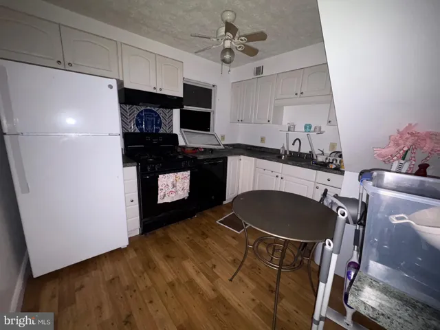 a kitchen with a sink cabinets and appliances