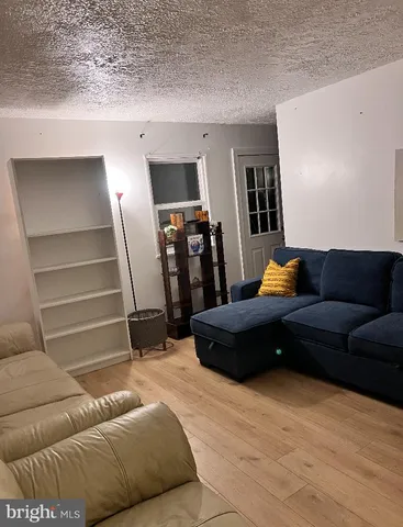 a living room with a couch and a ceiling fan
