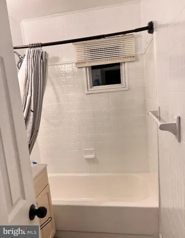a bathroom with a shower and a tub