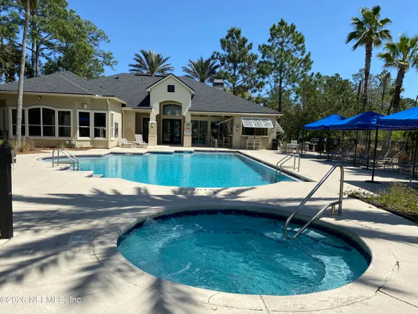 a view of a house with pool fire pit and sitting area