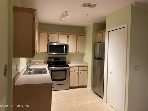 a kitchen with a refrigerator sink and microwave