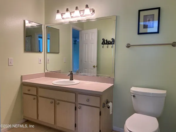 a bathroom with a sink mirror and toilet
