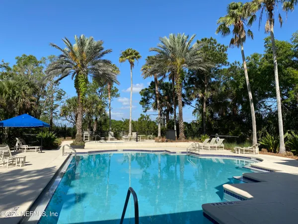 a view of a house with swimming pool and a yard