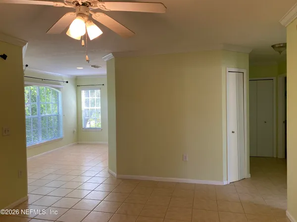 a view of a livingroom with a chandelier fan and fire place