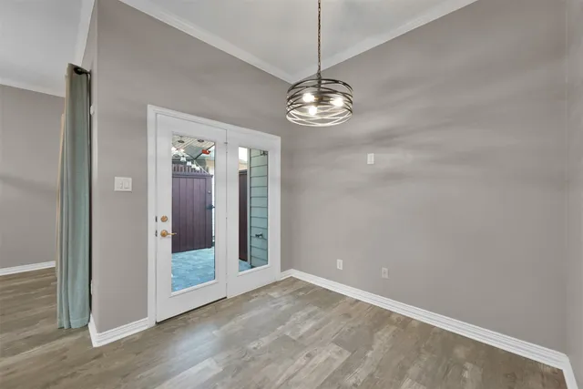a view of a chandelier in a room and wooden floor