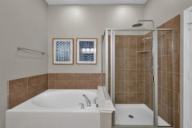 a bathroom with a bathtub and shower