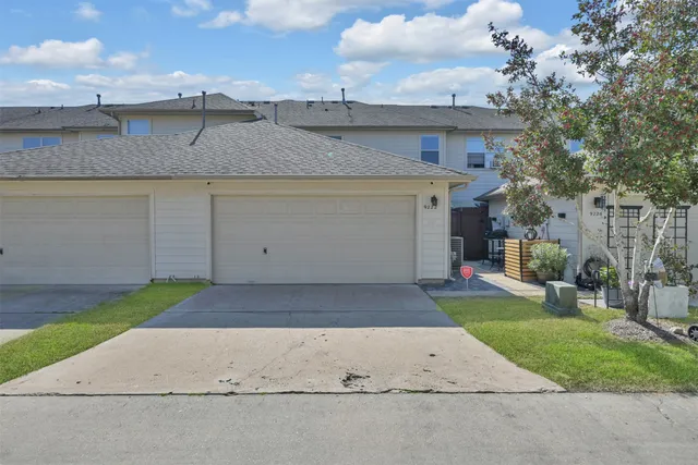 a view of a white house with a yard