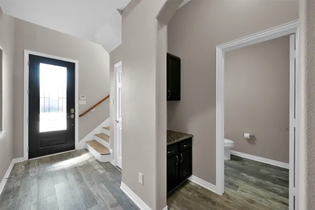 a view of hallway with wooden floor and staircase