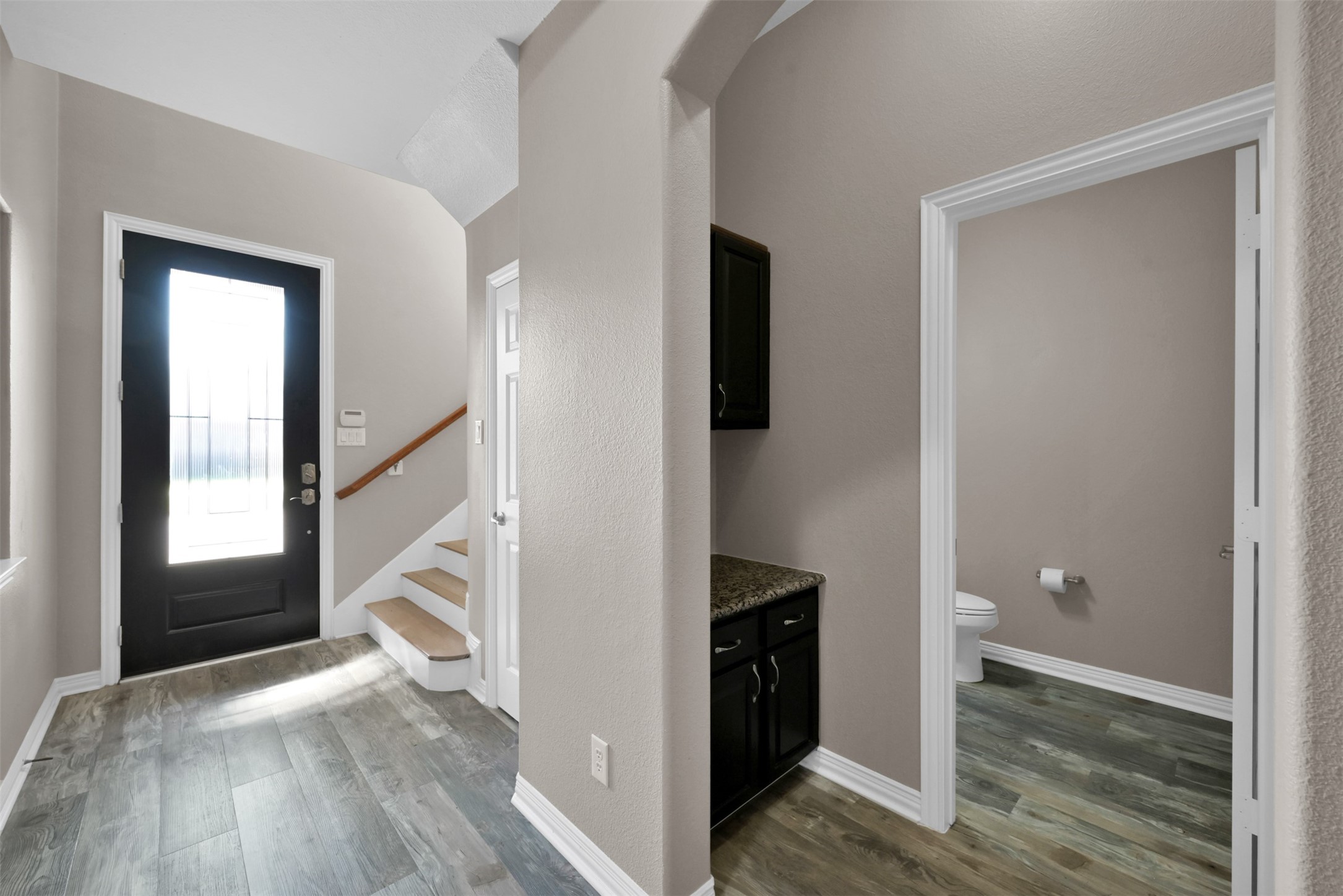 9222 Sunlight Oak Lane Houston, TX 77070 - Photo 4 of 29 a view of hallway with wooden floor and staircase